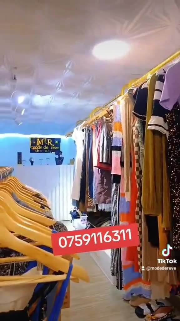 Intérieur de la boutique Mode de Rêve, portants et enseigne